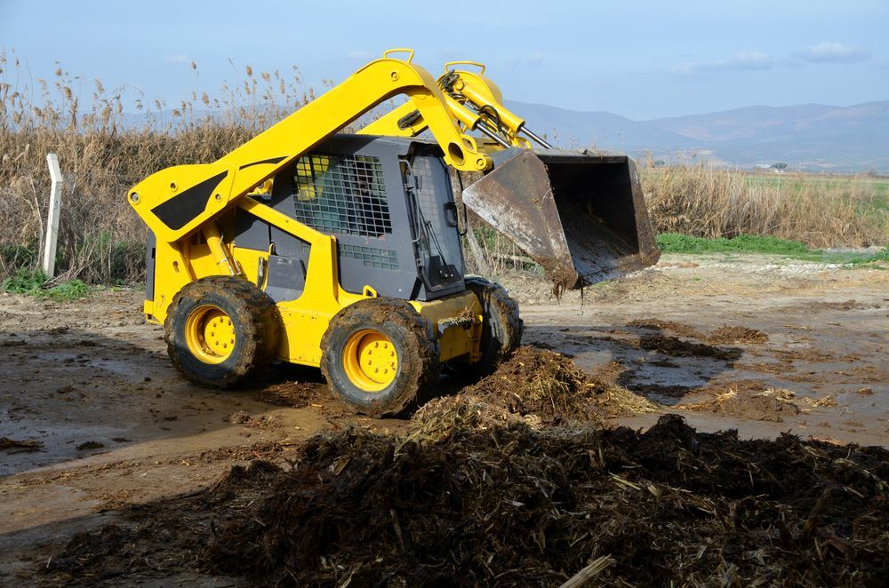 A White And Orange Bulldozer Is Parked In A Dirt Field — Eclipse Hire In  Tablelands, QLD