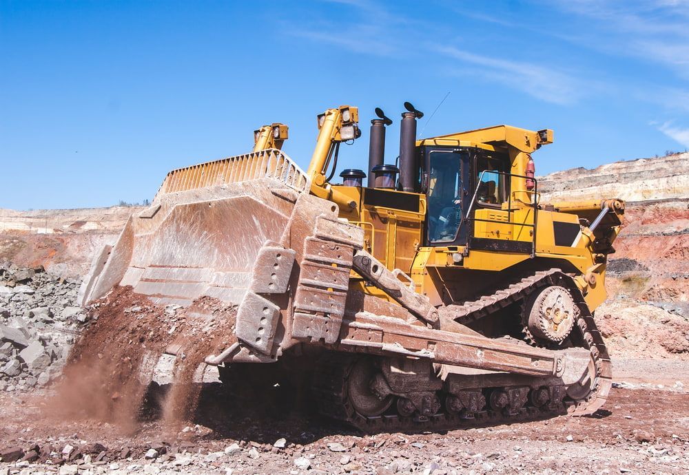 A Bulldozer Is Moving Dirt In A Dirt Field - Eclipse Hire In  Tablelands, QLD