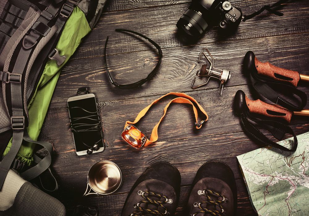 A Green Backpack Is Sitting On Top Of A Rocky Hill — Eclipse Hire In Cairns, QLD