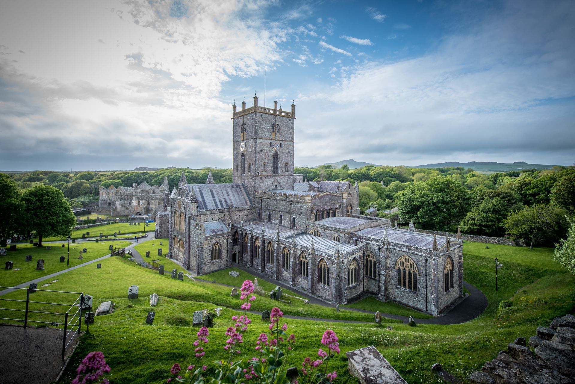 St Davids Cathedral in Pembrokeshire photographed by Beverley Thomas with wildflowers and dramatic s