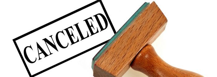 wooden stamp with the word canceled on it emphasizing the tax cancellation of student debt