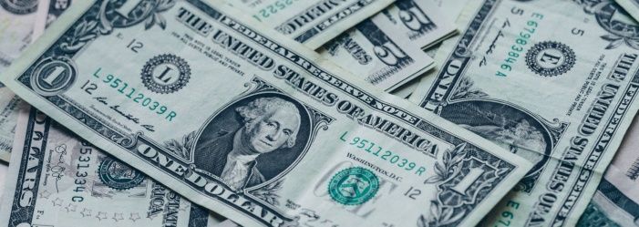a pile of one-dollar bills lying on top of each other emphasizing Debt Settlement Can Reduce What You Owe