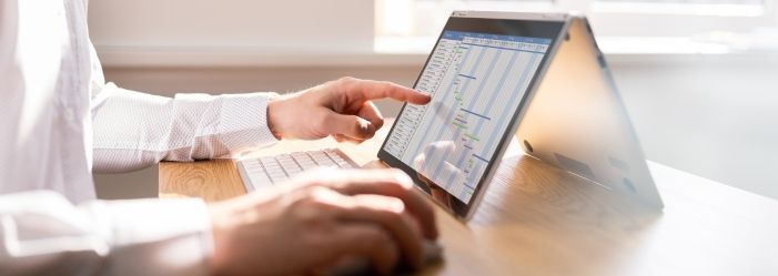 A person using an iPad emphasizes the idea of Mastering Your Money with Personal Finance Software.