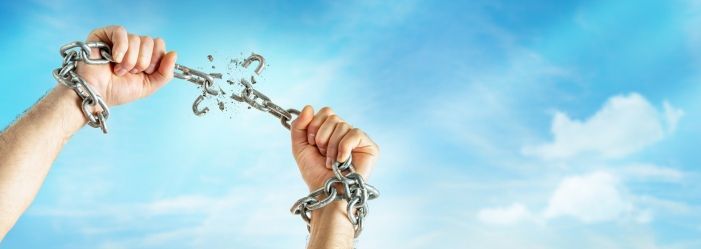 The image shows a hand breaking a chain, symbolizing the empowerment and freedom achieved through effective debt management and relief strategies, representing the breaking of financial constraints and burdens.