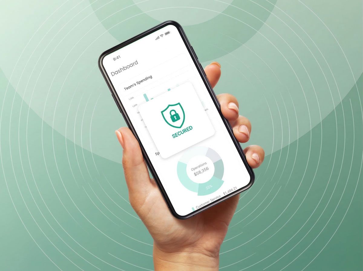 Hand holding a smartphone displaying a security app with a lock icon, green and white interface.