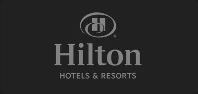 Hilton Hotels & Resorts logo in white on a dark background.