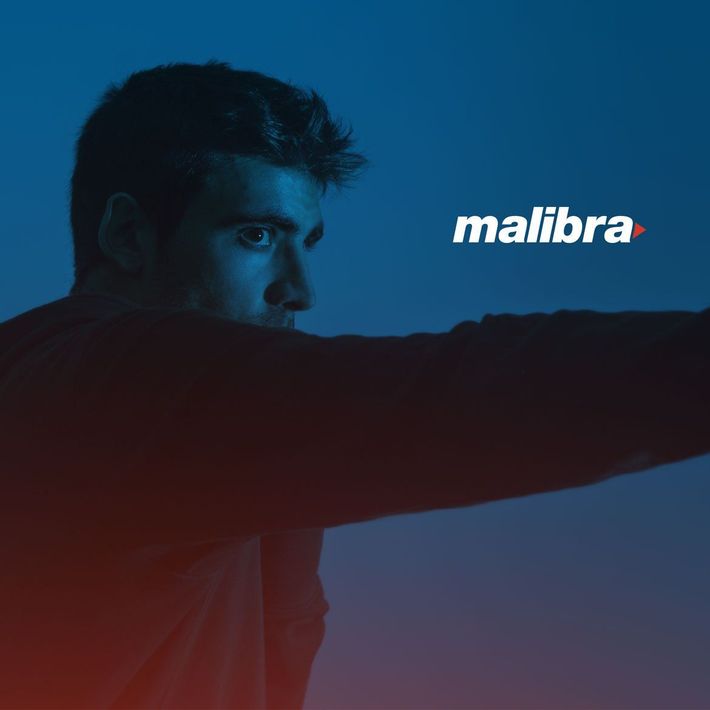 Man in red shirt extending arm in blue-lit scene with Malibra logo
