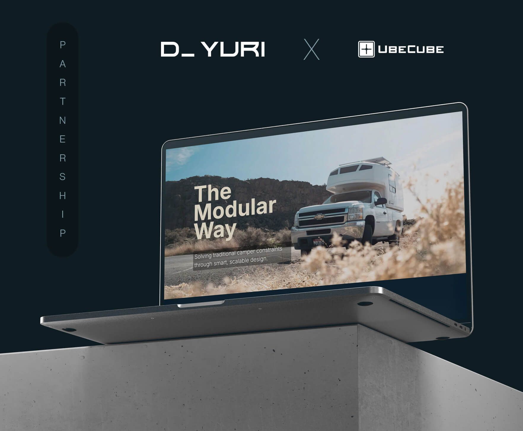 Laptop displaying a truck ad with “The Modular Way” on a dark background, resting on a concrete pedestal.