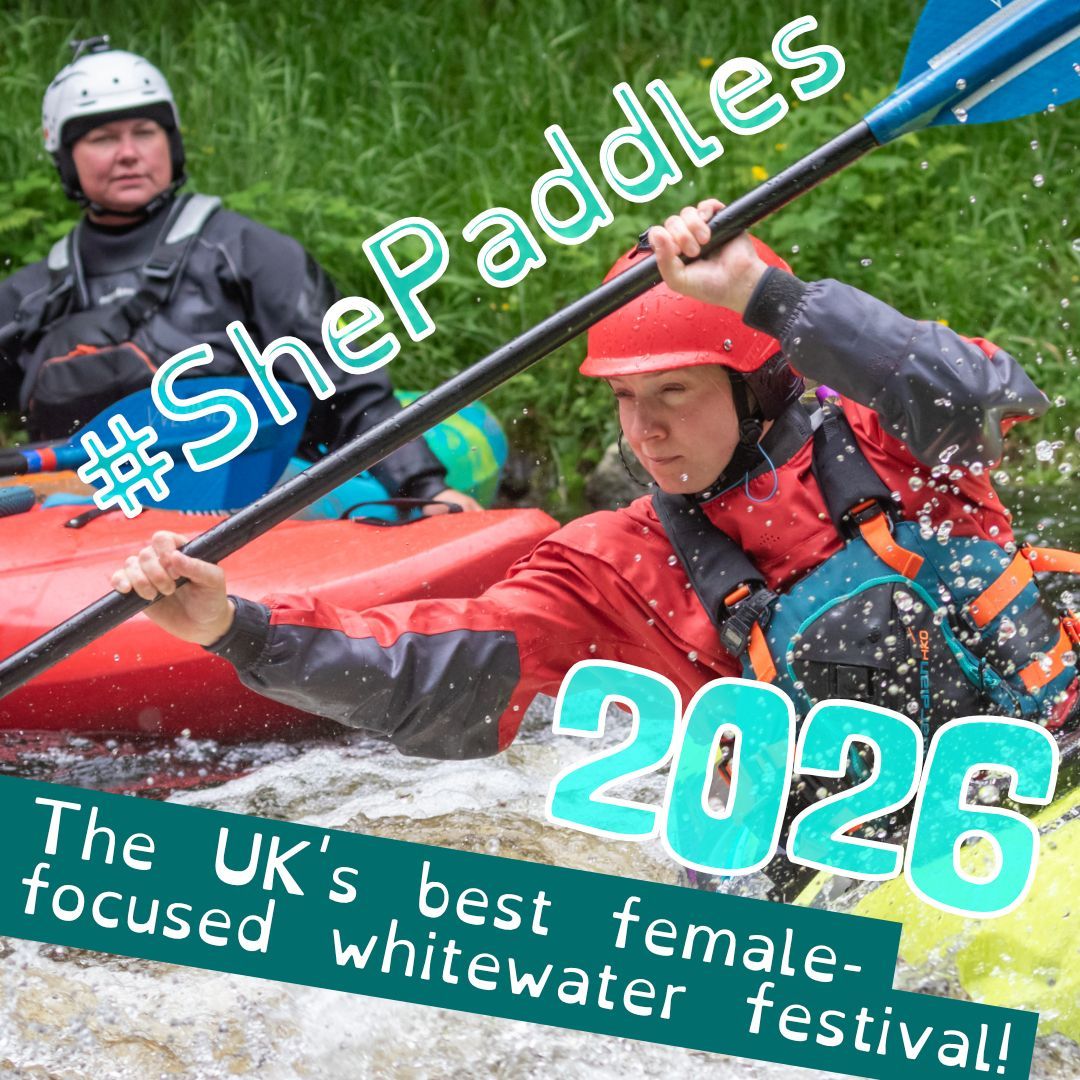 A female kayaker concentrates as she leans into a rapid, watched over by a woman coaching her.
The caption reads '#ShePaddles 2026. The UK's best female-focused whitewater festival!'