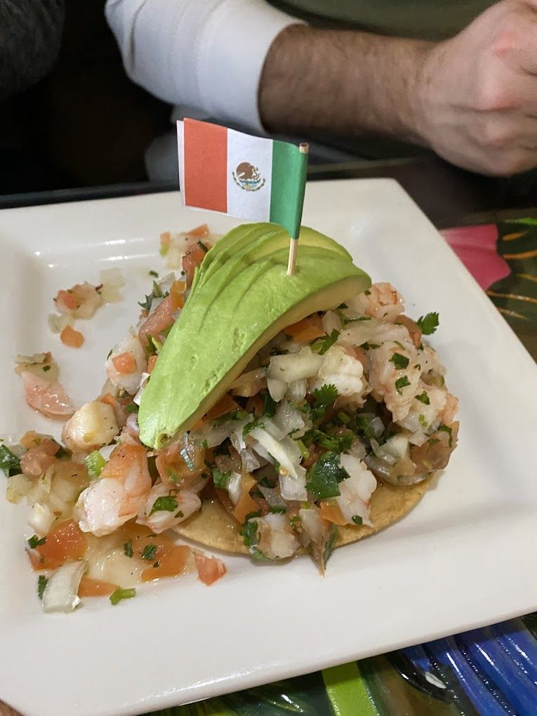 A plate of food with a flag sticking out of it.