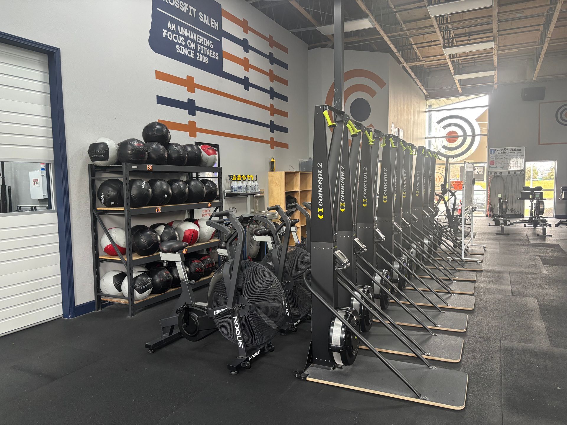 A gym filled with lots of exercise equipment and dumbbells.