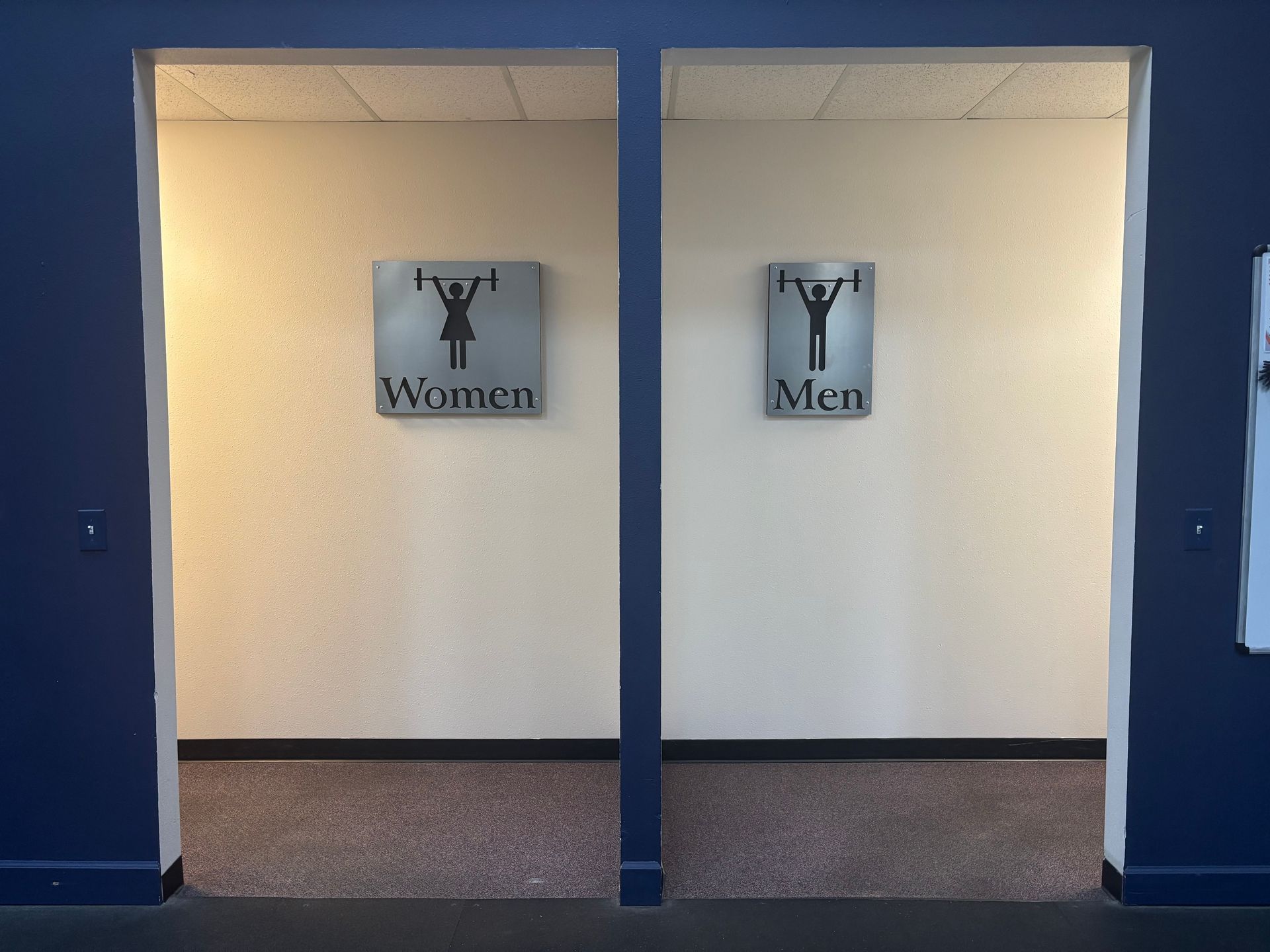 A men 's and women 's bathroom with signs on the wall
