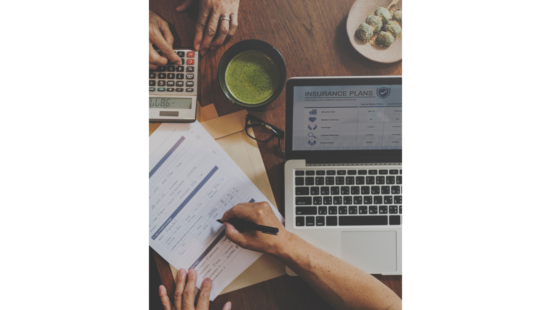 a group of people are sitting at a table with a laptop and a calculator .