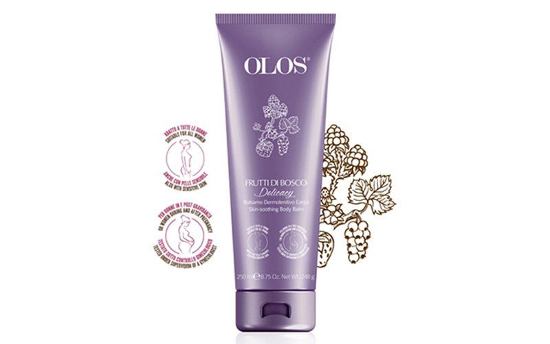 Tubetto cosmetico OLOS viola con decorazioni floreali e sigilli di cera decorativi su sfondo bianco.