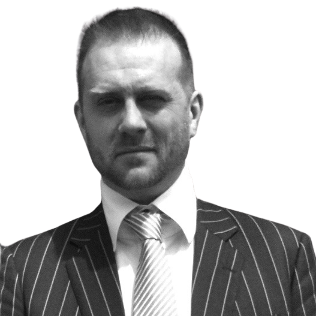 A man in a suit and tie is looking at the camera