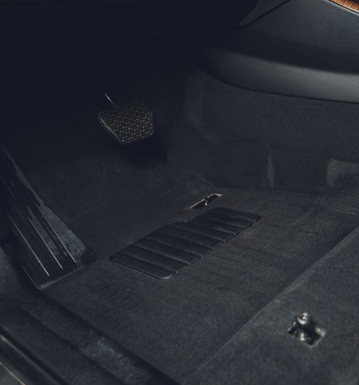 Car interior with automatic gear shift and center console controls, shown in dark trim.