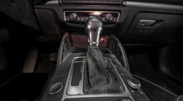 Car interior center console with automatic gear shift and dashboard controls, black trim and silver accents