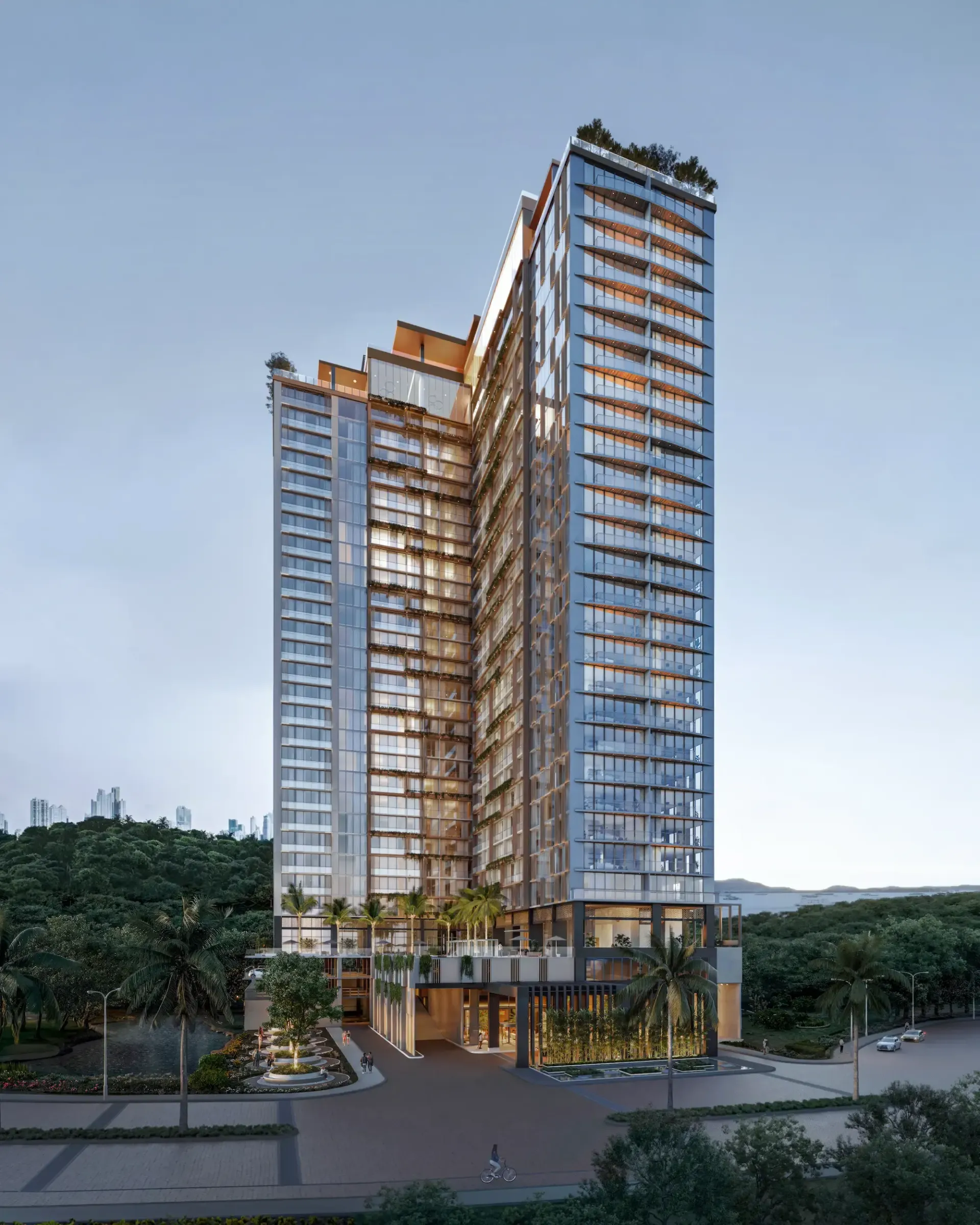 Immeuble moderne en verre de grande hauteur, avec un socle paysager et des échafaudages sur fond de ciel dégagé
