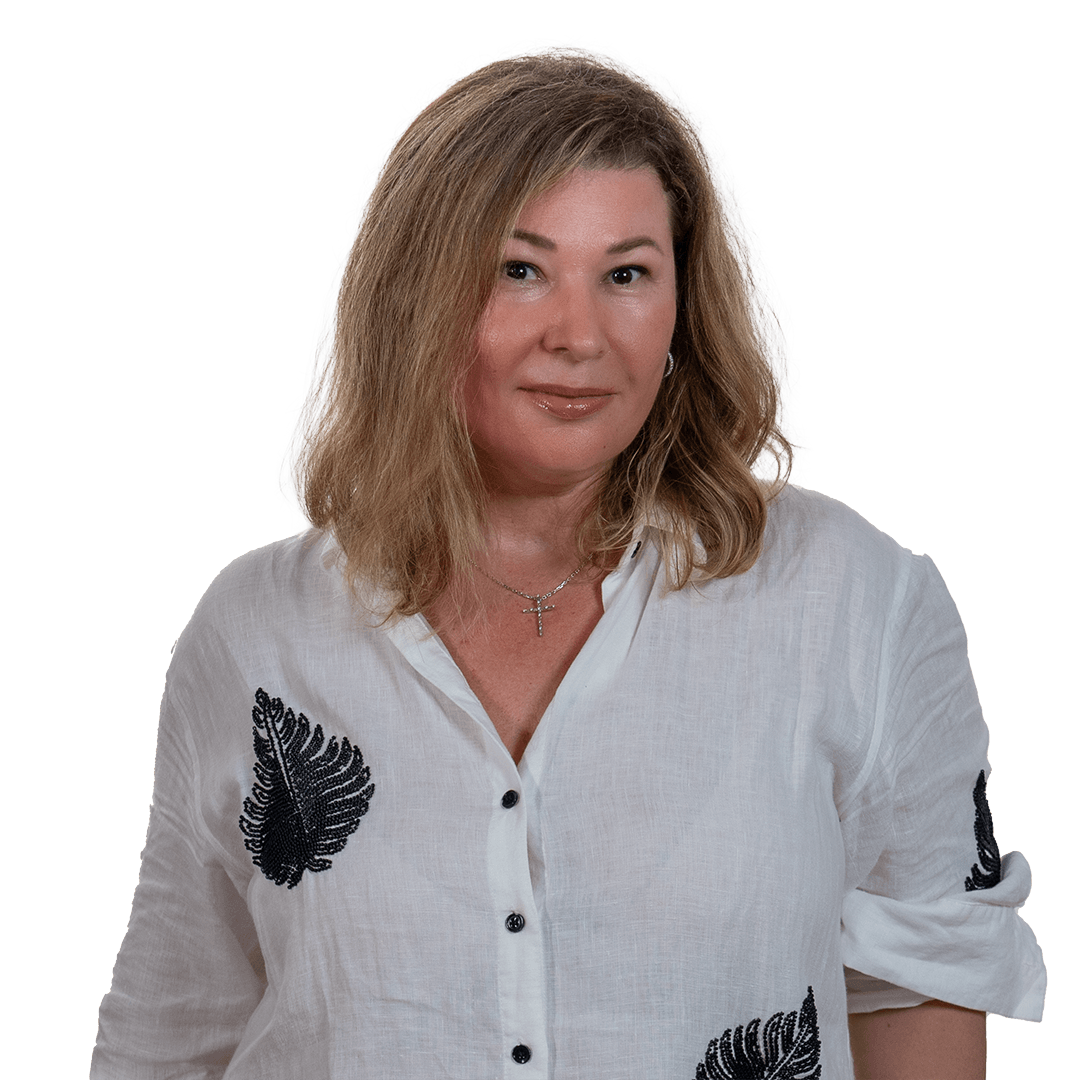 Woman in a white blouse with black leaf embroidery against a white background