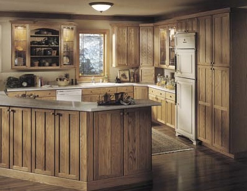 Warm wood kitchen with island, white appliances, and a window over the sink
