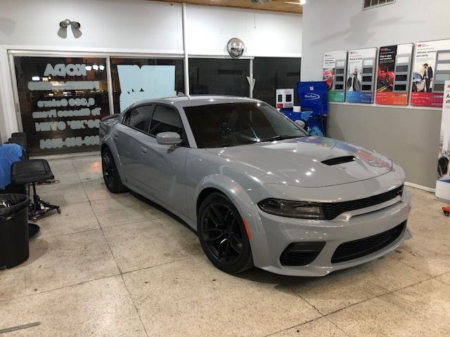 Gray Dodge Charger in a shop.