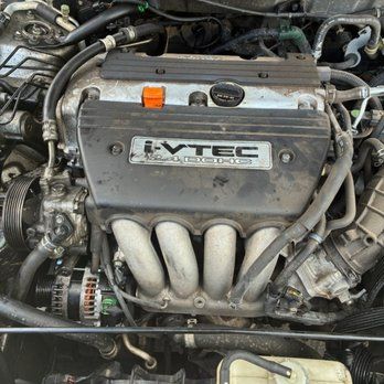Experienced mobile mechanic performing diagnostics on a vehicle at a home driveway.