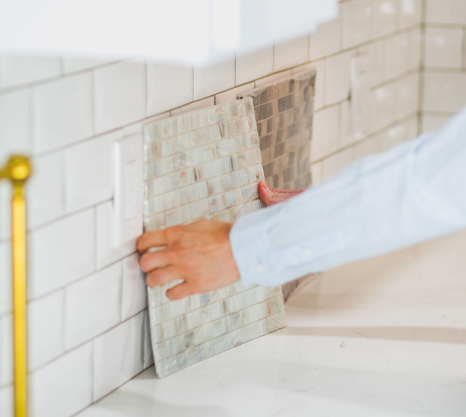 A woman placing sample tile colors