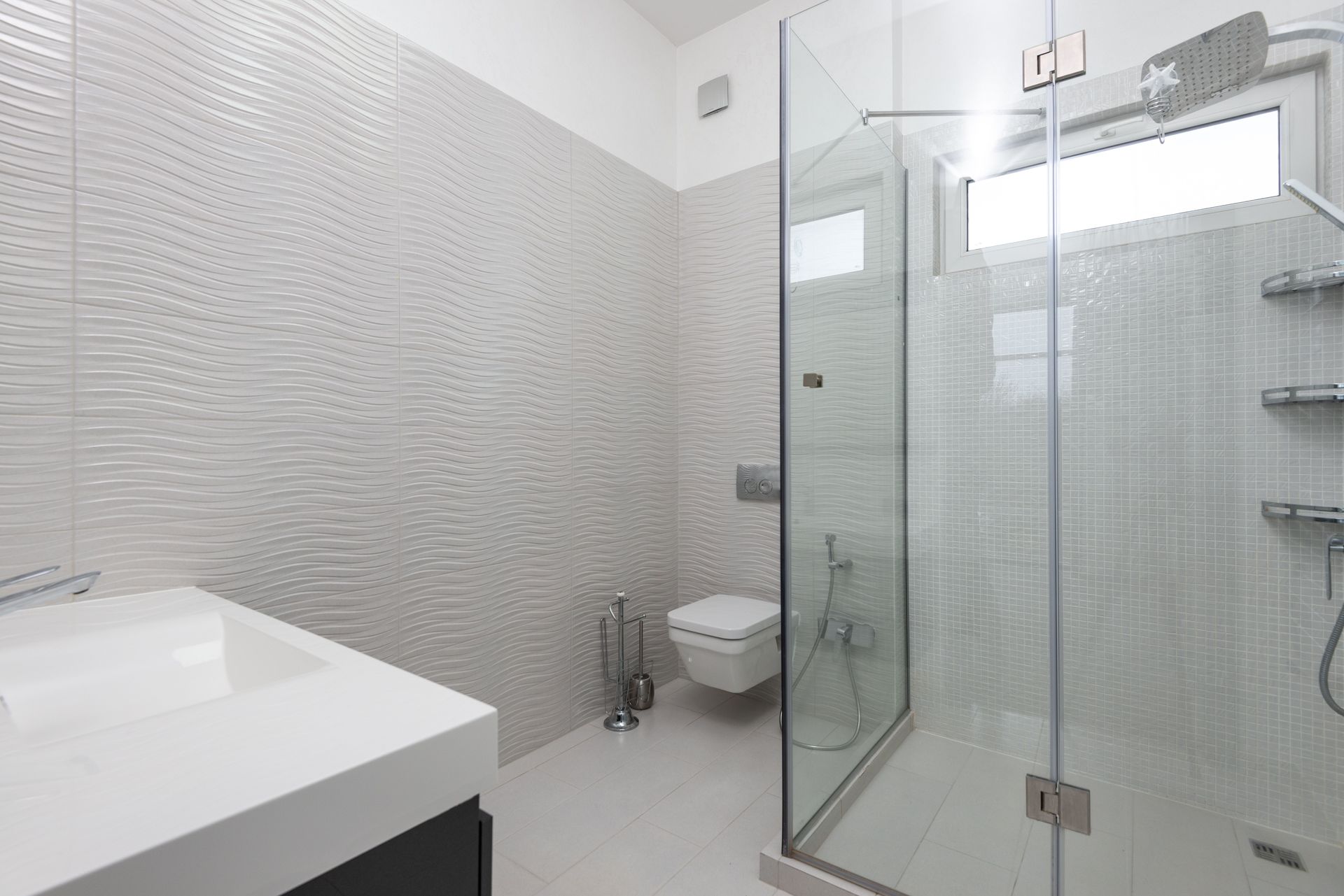 A newly remodeled bathroom with a glass-door shower