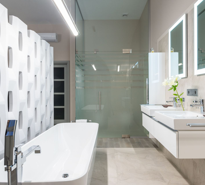A bathroom with shower and free-standing bathtub