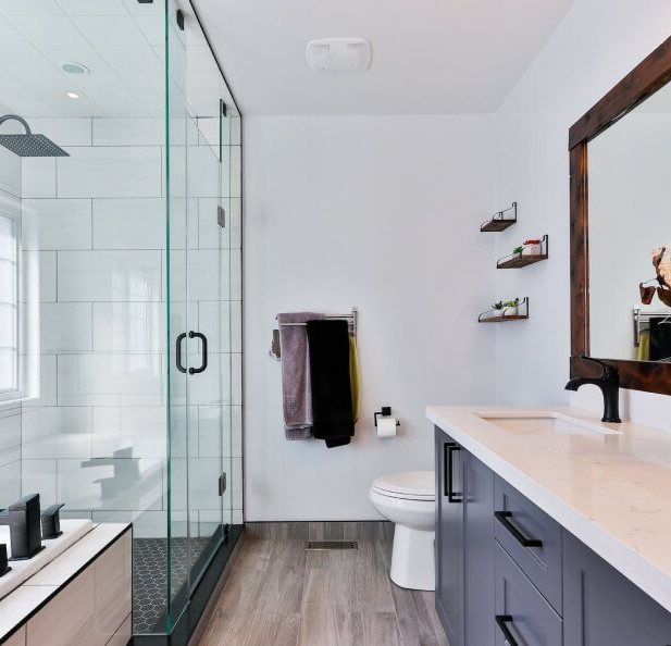 A white bathroom with glass-door shower 