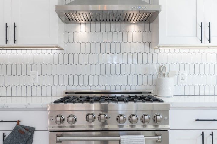 A new kitchen oven, backsplash, and cabinets