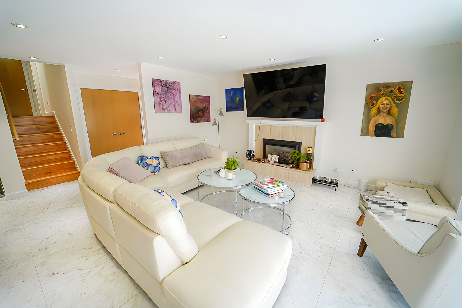 A living room with a white couch and a fireplace