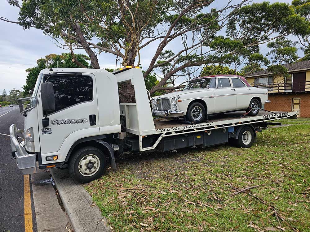 A Tow Truck Is Carrying The Classic Car — Optimum Towing in Nowra, NSW