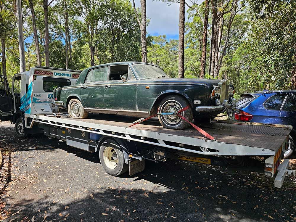 Green car being towed after breakdown — Optimum Towing in Bomaderry, NSW