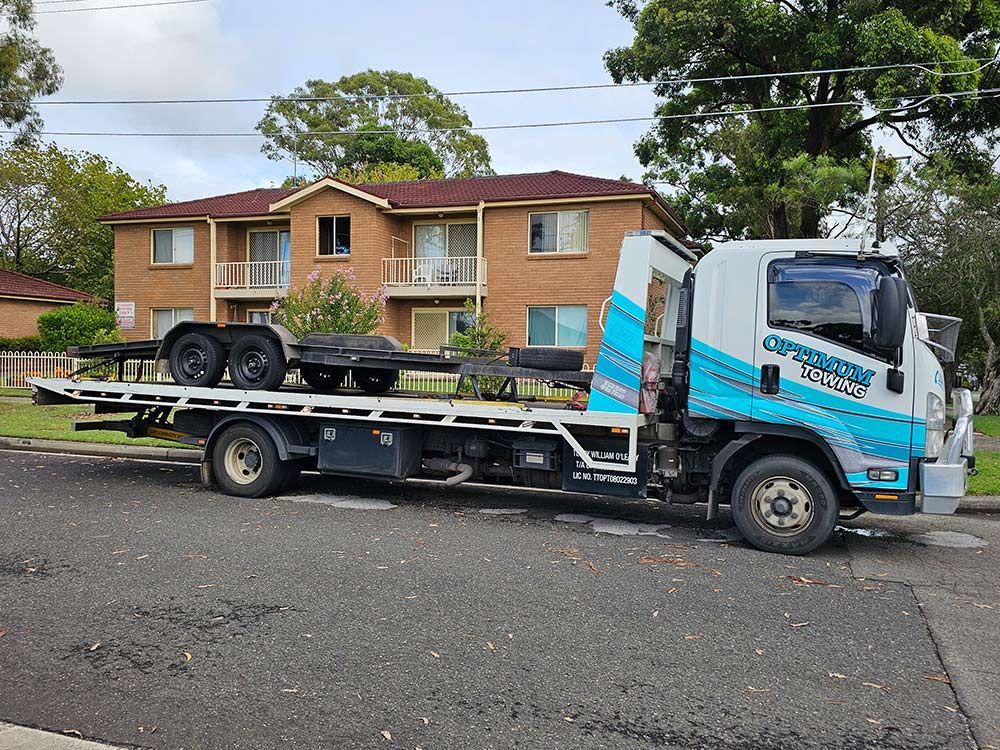 A Tow Truck Is Carrying Truck Frame Parked — Optimum Towing in Bomaderry, NSW