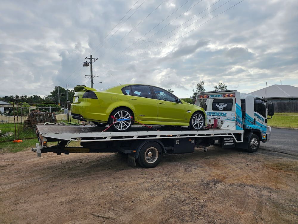 Towing Service The Tow Truck With The Loaded Old Damaged Car Which Stopped Working — Optimum Towing in Culburra Beach, NSW