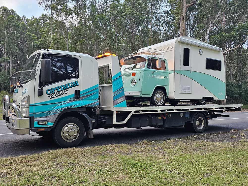 A Tow Truck Is Towing A Camper Van — Optimum Towing in Bomaderry, NSW