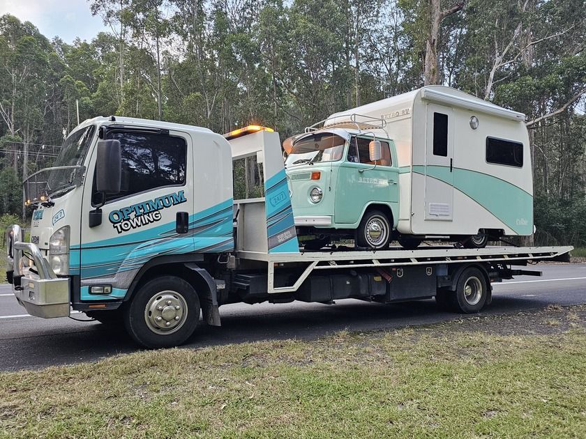 A Tow Truck is Towing a Camper and a Car — Optimum Towing in Bomaderry, NSW
