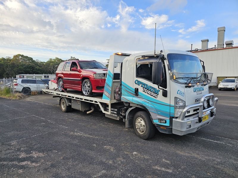 A Tow Truck is Carrying a Red Suv and a White Suv — Optimum Towing in Bomaderry, NSW
