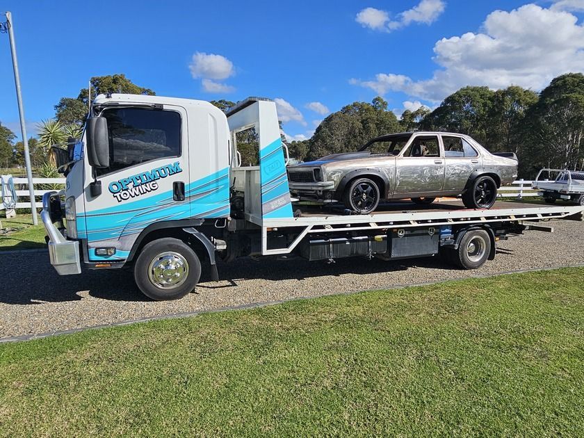 A Tow Truck With a Car on the Back of It — Optimum Towing in Bomaderry, NSW