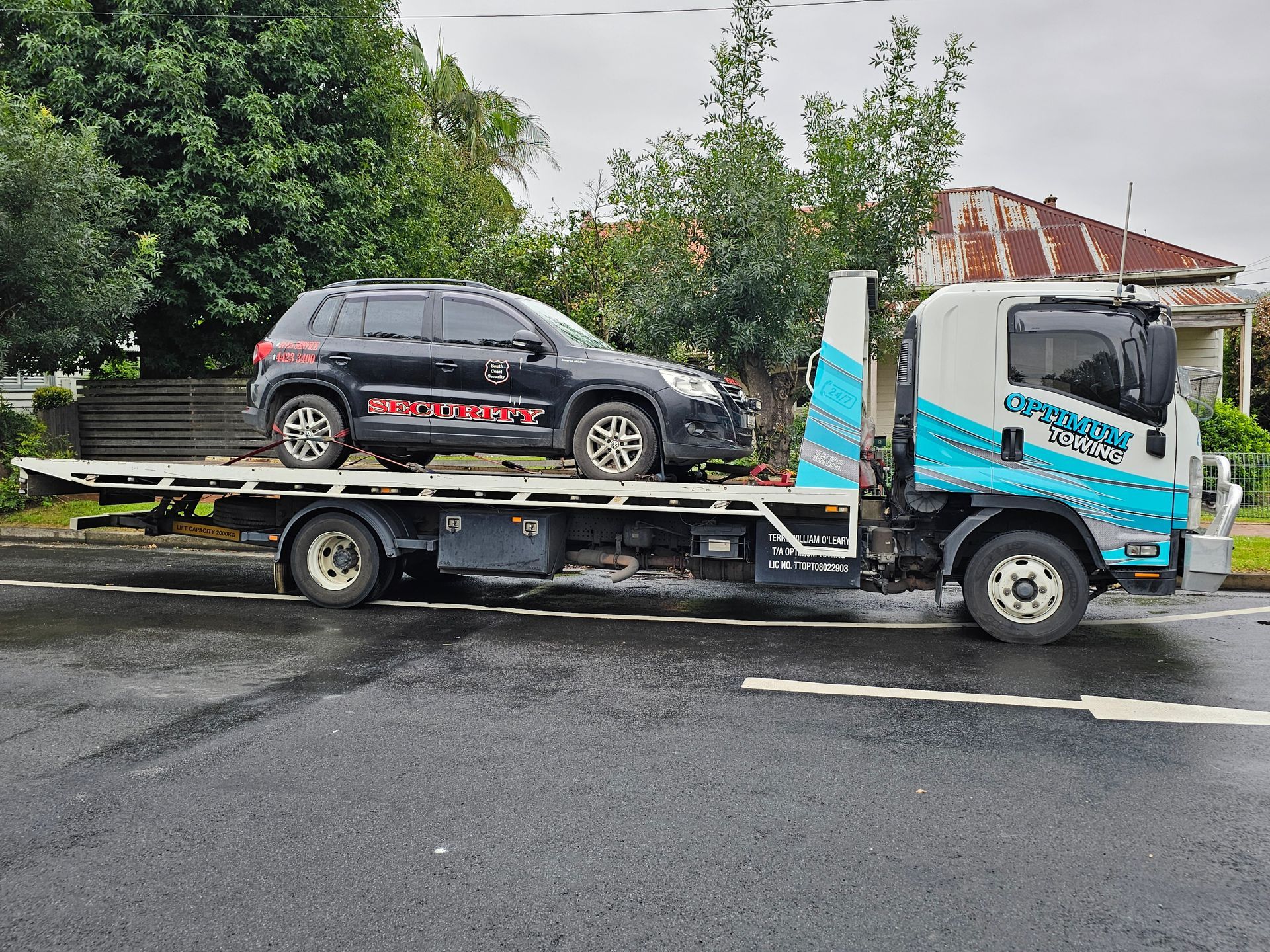 Black Suv on a Flatbed Towing Truck