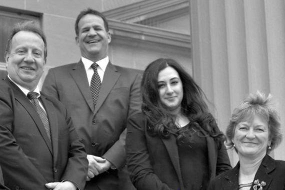 A group of people in suits and ties are posing for a picture. A group of people in suits and ties are posing for a picture.