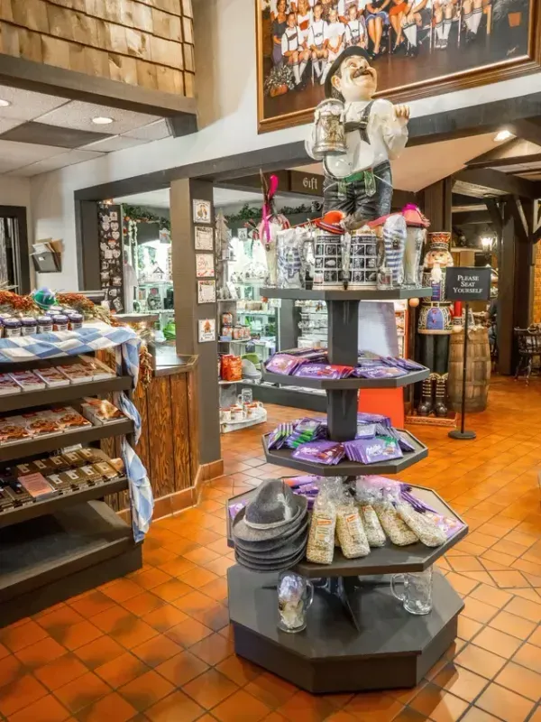 Gift shop display with stacked shelves of snacks and souvenirs in a rustic store interior