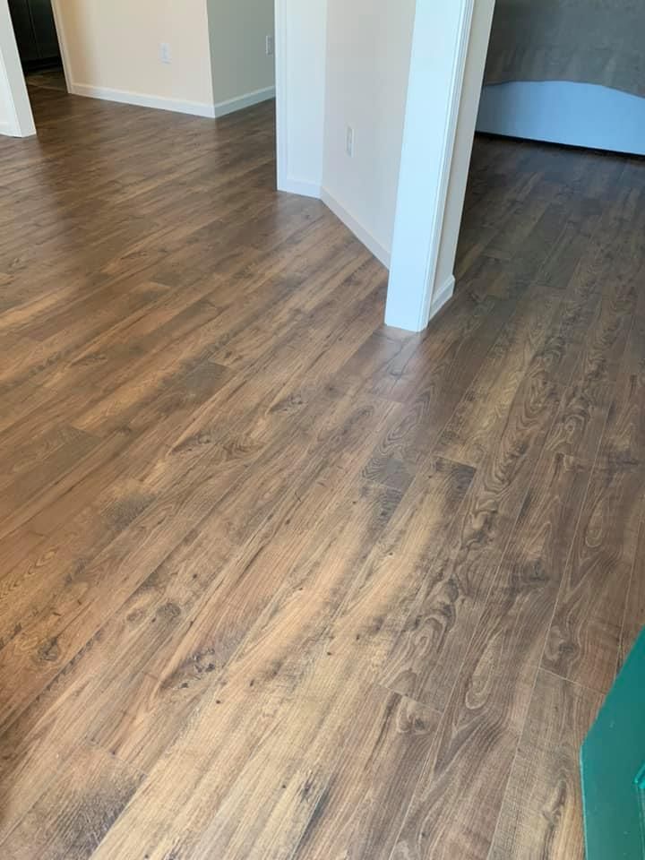 A close up of a wooden floor in a room.
