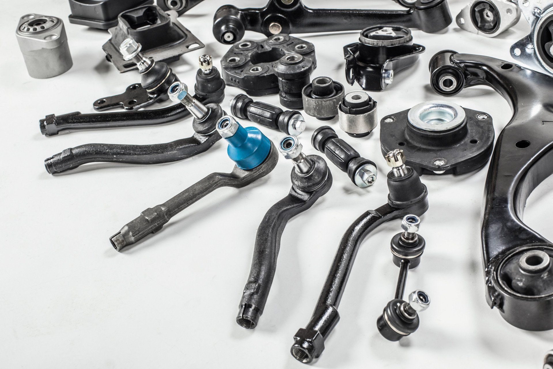 There are many different types of car parts on the table.