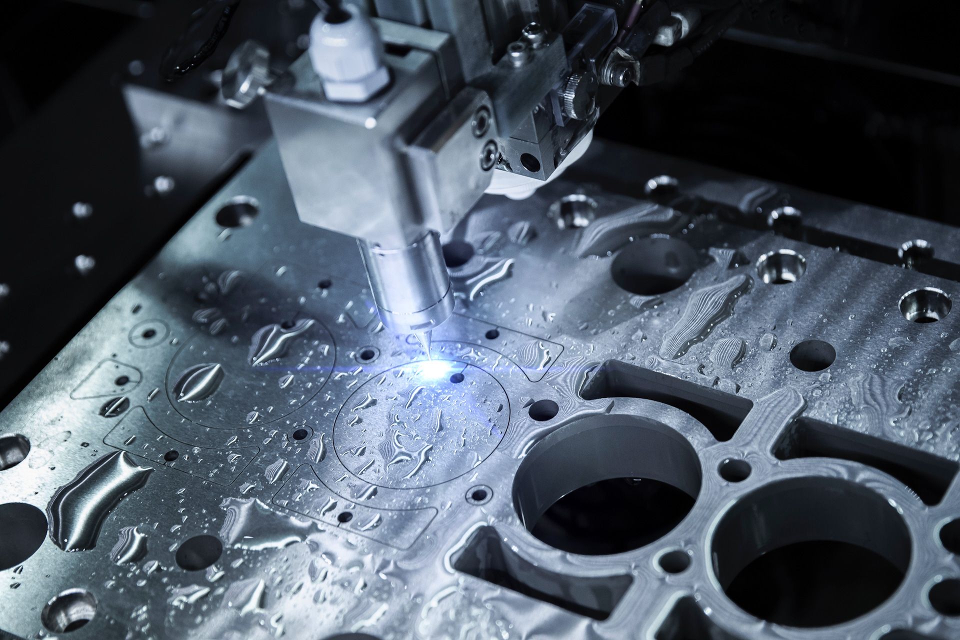 A machine is cutting a piece of metal with a laser.