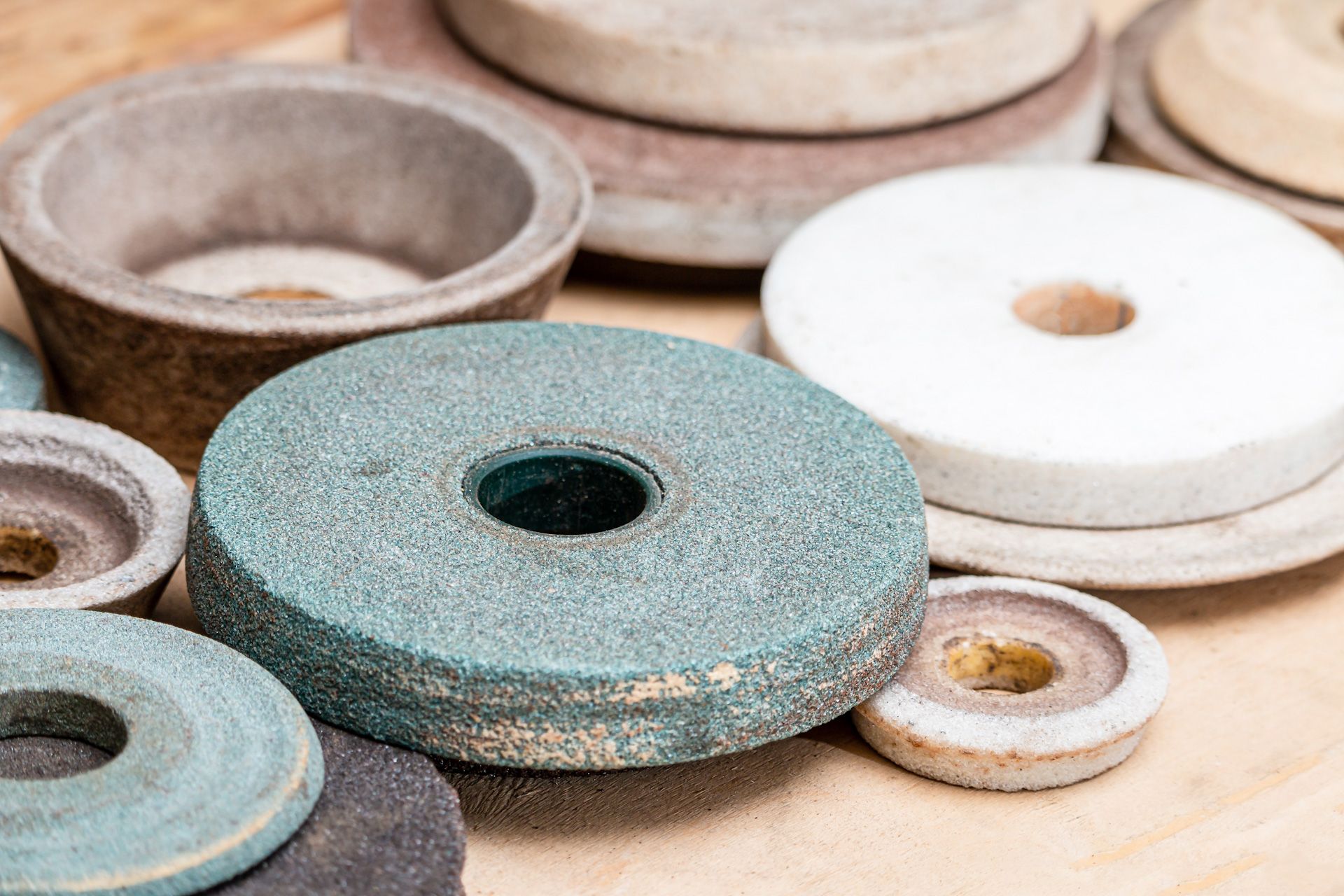 There are many different types of grinding stones on the table.