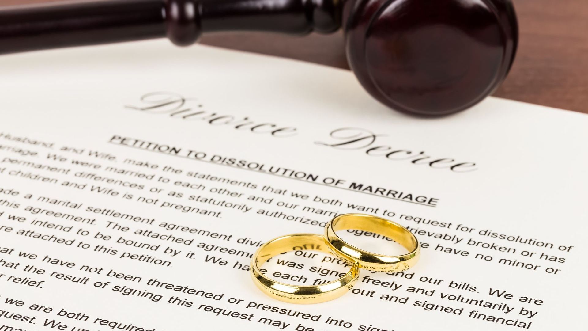 A judge 's gavel is sitting on top of a divorce decree