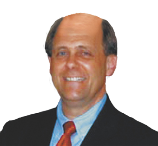 A bald man in a suit and tie smiles for the camera