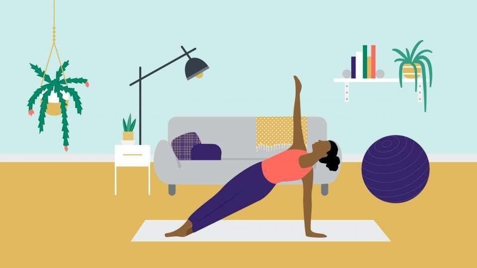 A woman is doing a yoga pose on a yoga mat in a living room.
